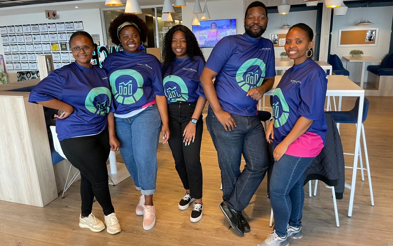 Colleagues in ImpactBoard shirts at a team sync